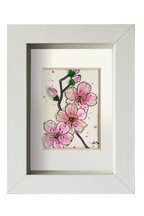 Cuadro con dibujo de rama de almendro con flores de tinta y acuarela con vidrio de mar resaltando los pétalos y los capullos